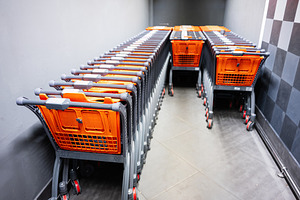 Row of organized shopping carts in a supermarket hallway with modern surroundin, a Photo by AS photostudio