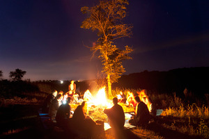 People sitting around the bonfire