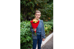 Young Pupil Boy Holding a Bouquet, a School & Education Photo by Jan Jack Russo Media