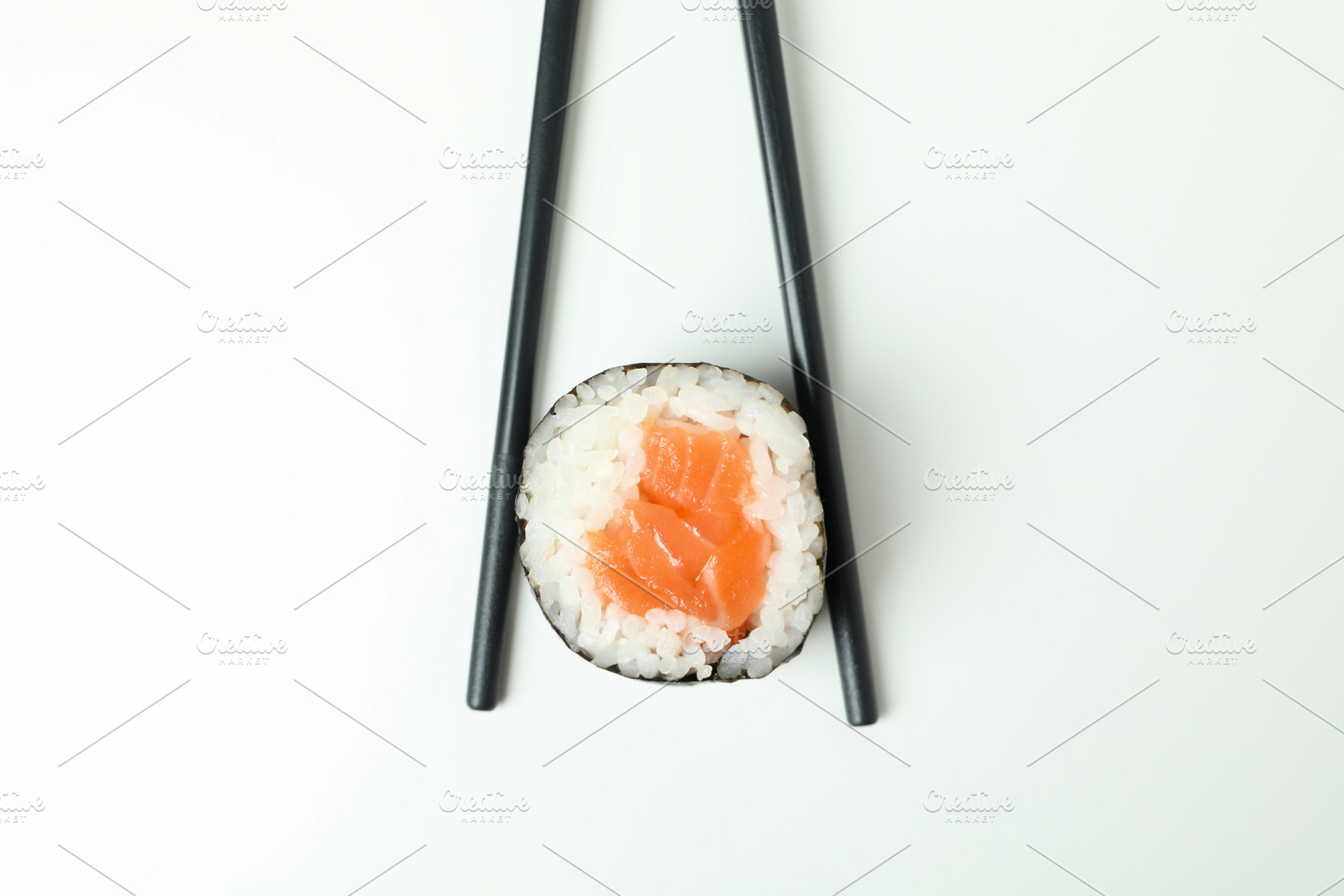 Chopsticks with maki on white background, close up, a Food & Drink Photo by AtlasStudio PRO