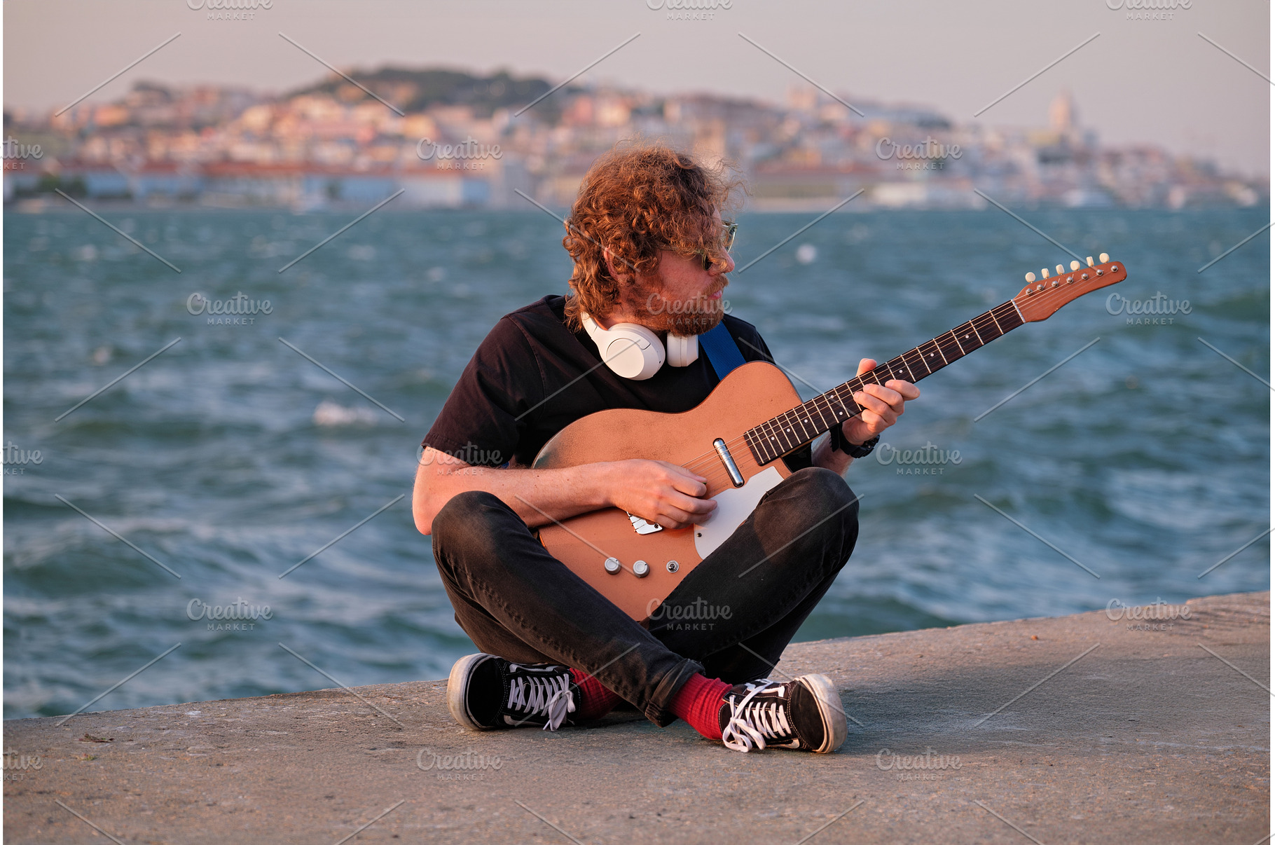 Street musician playing electric, a Person Photo by f9photos