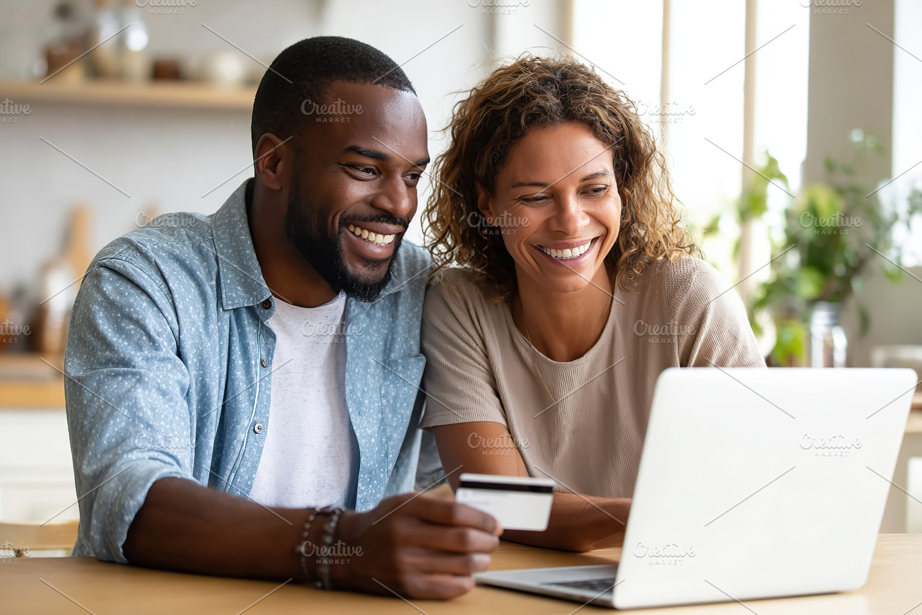 Couple enjoying online shopping together at home during daytime, a Photo by AlyaAnd