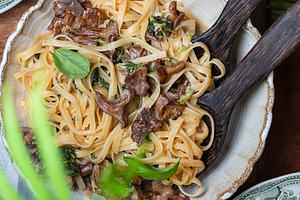 Plate of pasta with forest chanterel featuring food, parsley, and pasta