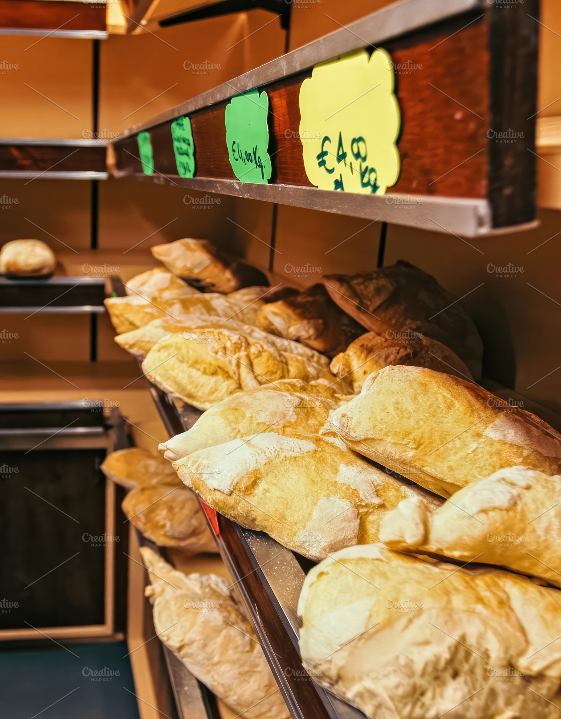 Freshly baked loaves of bread displayed on shelves in a bakery shop, an Abstract Photo by Antonio Gravante Market