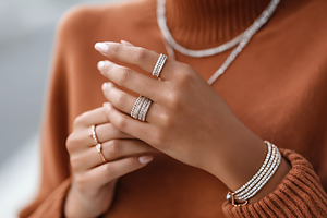 Anonymous influencer woman showcases stylish jewelry in cozy outfit during fall, a Person Photo by OSORIOartist