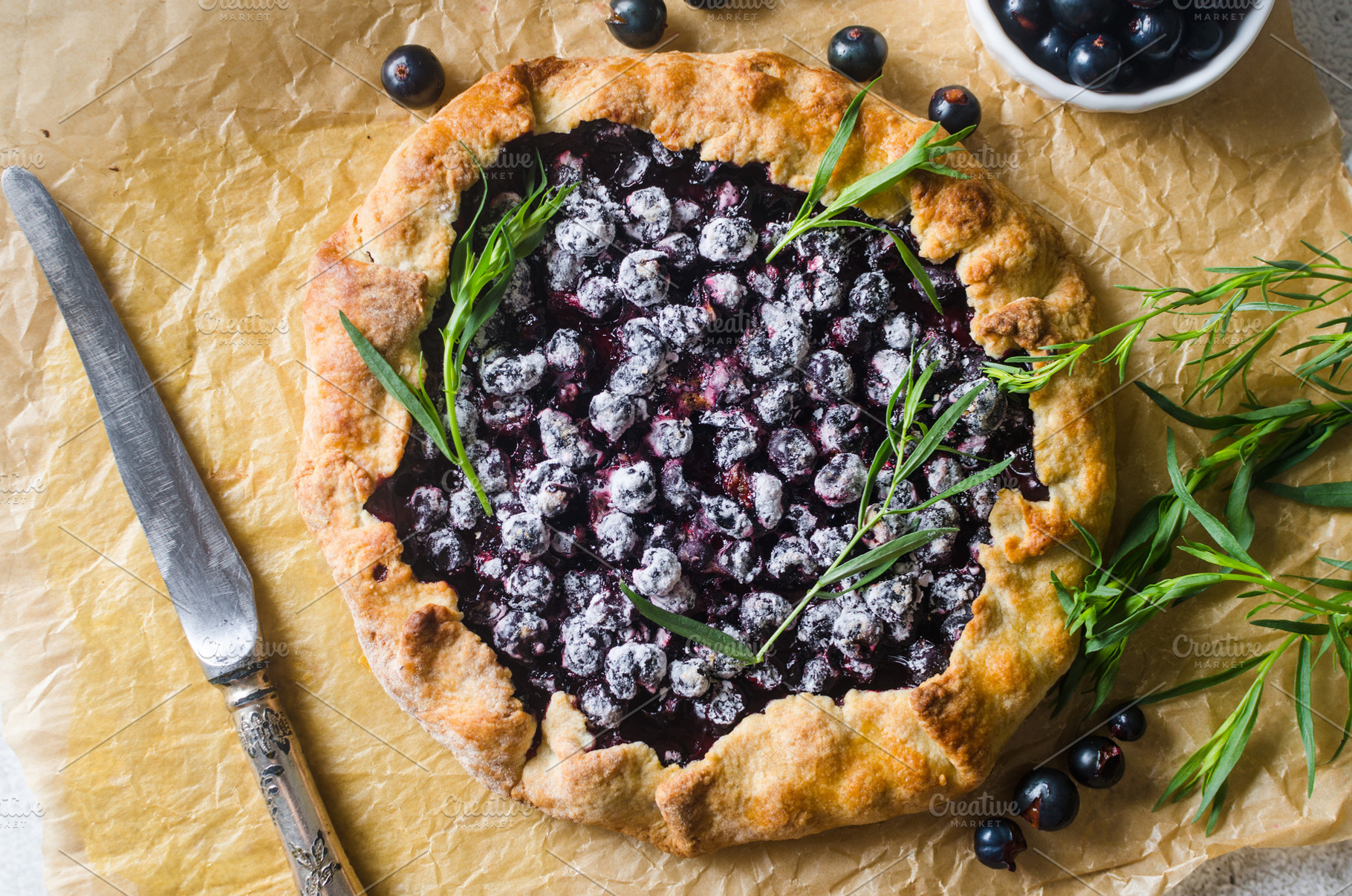 Homemade blackcurrant galette on old concrete background., a Food & Drink Photo by vimart