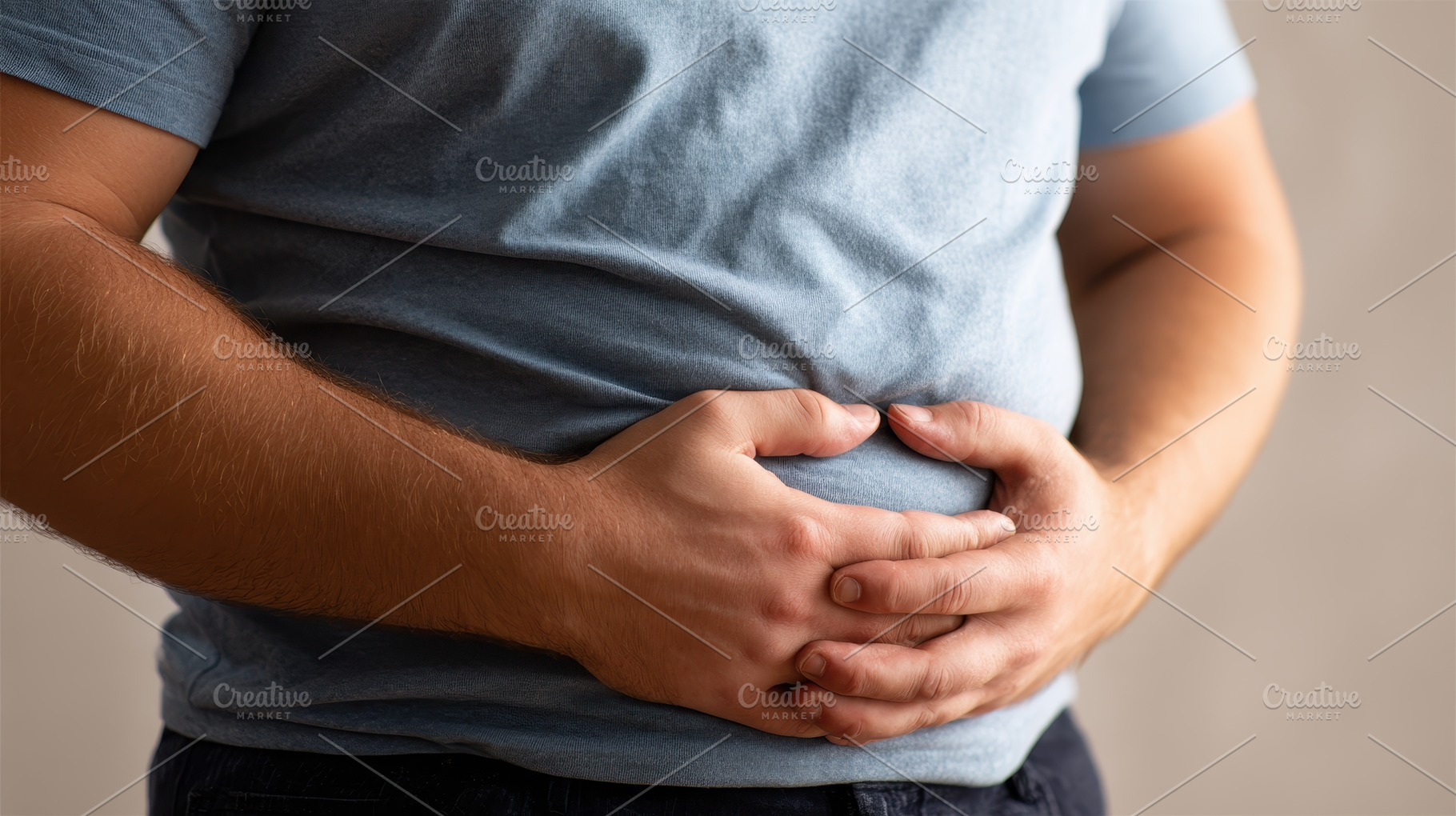 Man holding his stomach in pain abdo, a Photo by Pixeness Studio