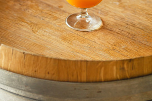 Wheat ale on a wooden barrel containing alcohol, ale, and amber