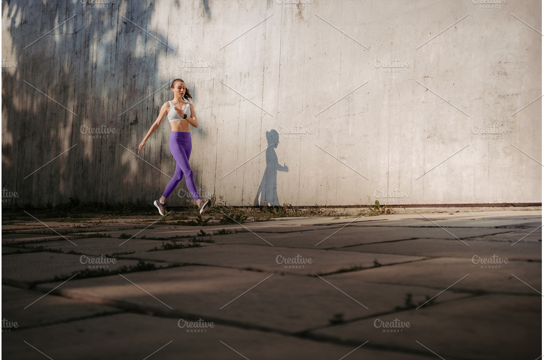 Fitness woman running in front of, a Sports & Recreation Photo by HalfPoint
