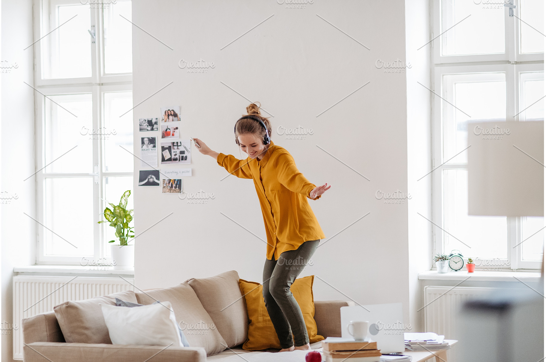 Young woman dancing on the couch, a Beauty & Fashion Photo by HalfPoint