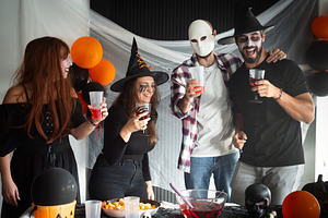 Friends laughing together at a Halloween costume party, a Person Photo by etorres69