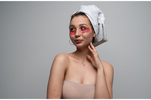Young woman applying under eye, a Health & Medical Photo by volodymyrshtun13795