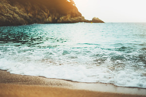 Beach on sunny day featuring beach, sand, and background