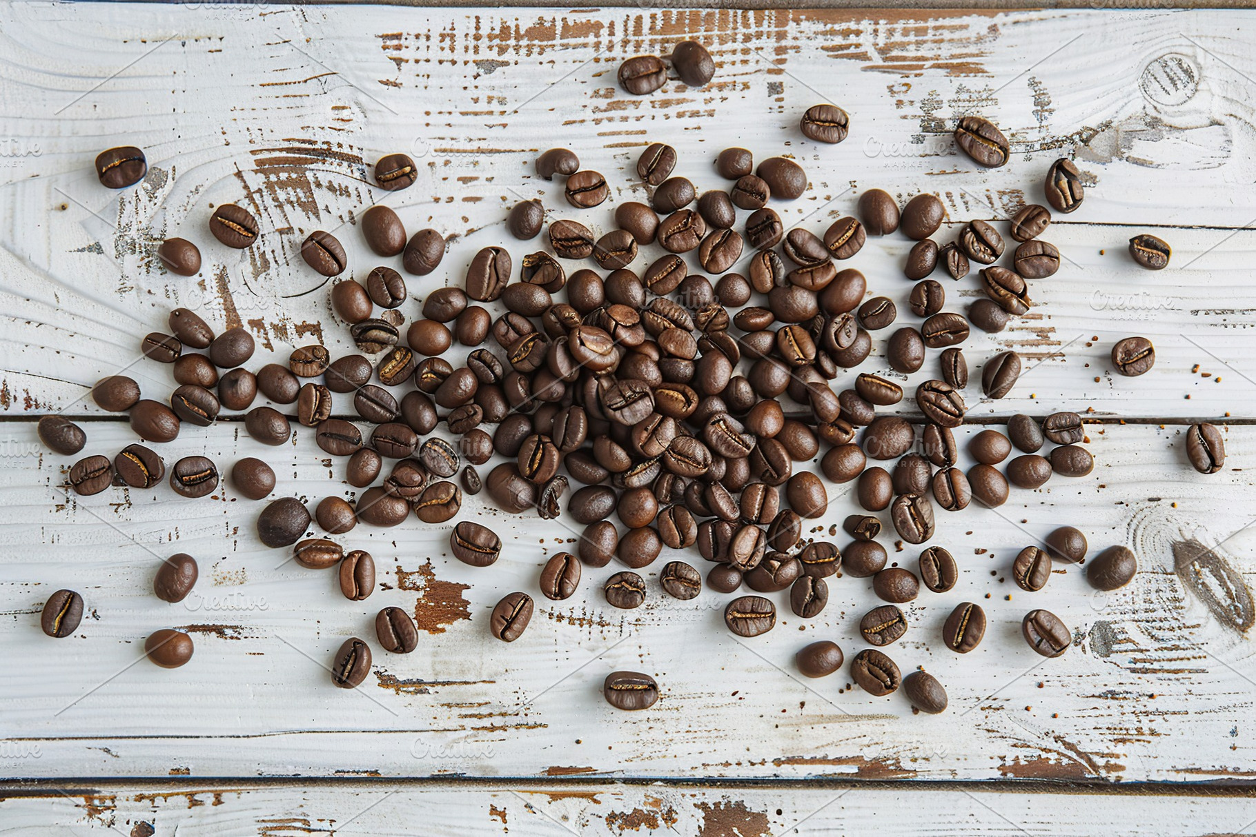 Heap of coffee beans on wooden table, a Food & Drink Photo by AlyaAnd