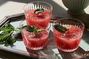 Refreshing watermelon mint cocktails with ice cubes on a serving tray, perfect, a Photo by Studio ANNA