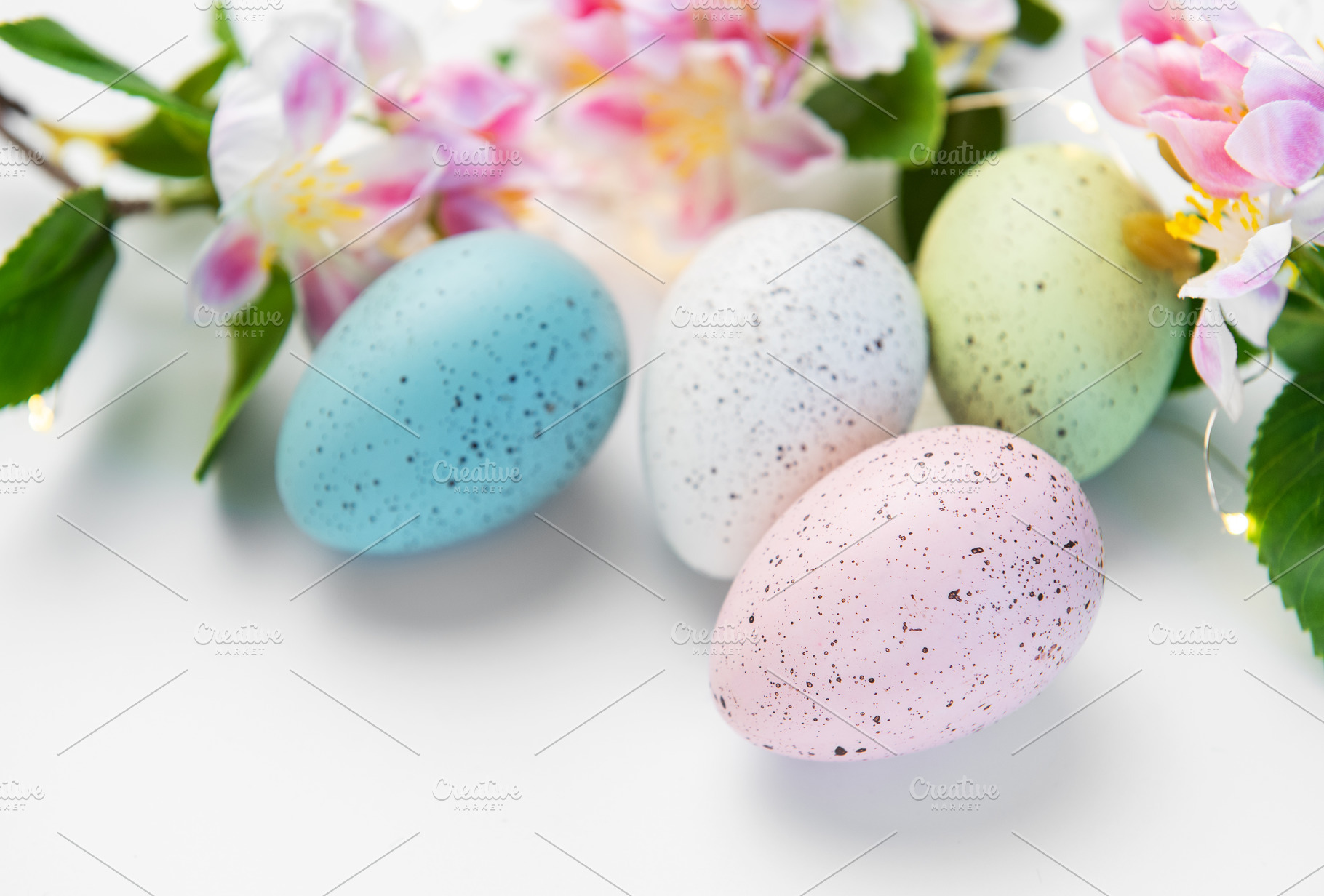Pastel speckled eggs with spring blossoms celebrating easter hol, a Holiday Photo by Olena Rudo