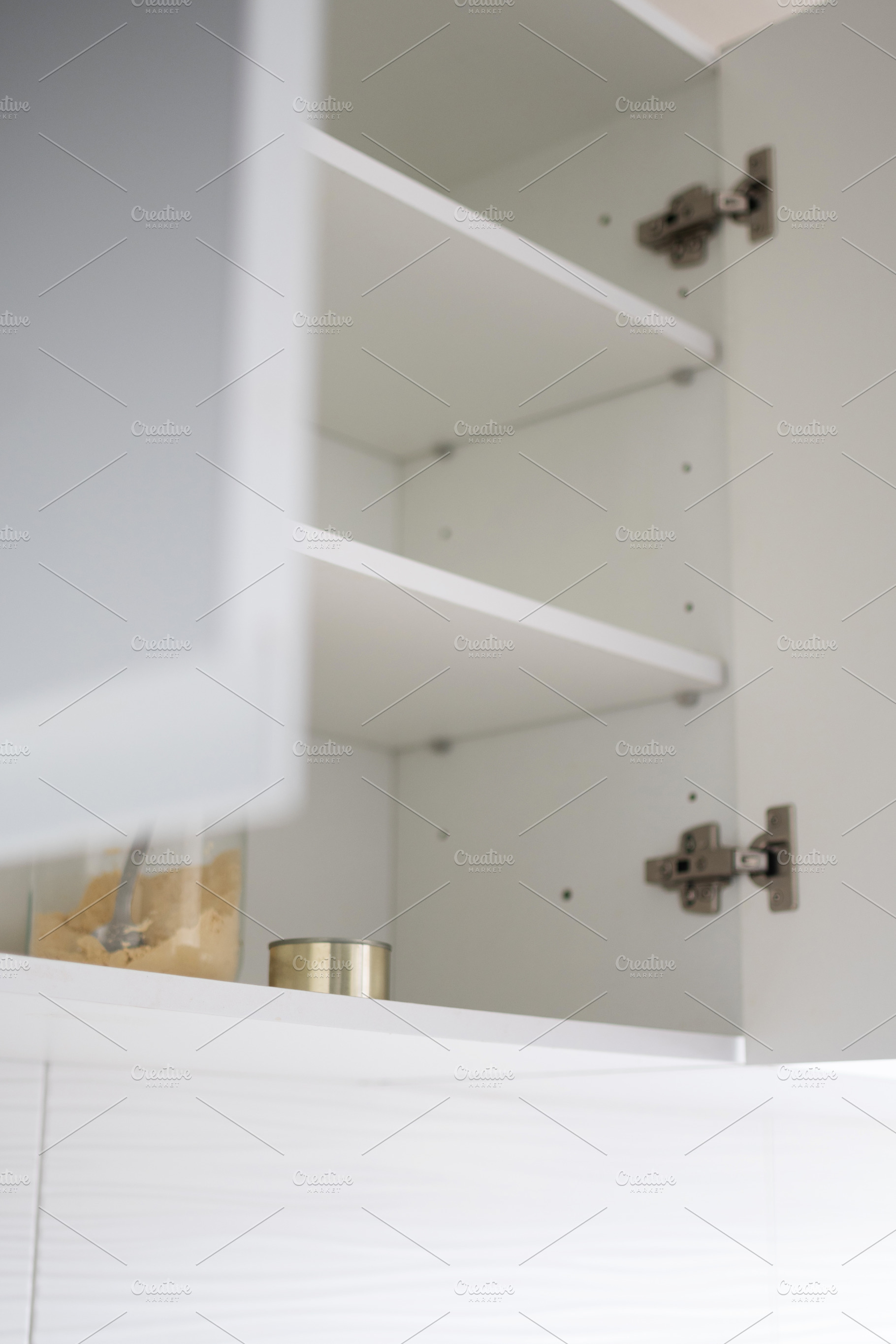 Minimalist kitchen cabinet with empty shelves and simple food storage at home, a Food & Drink Photo by etorres69