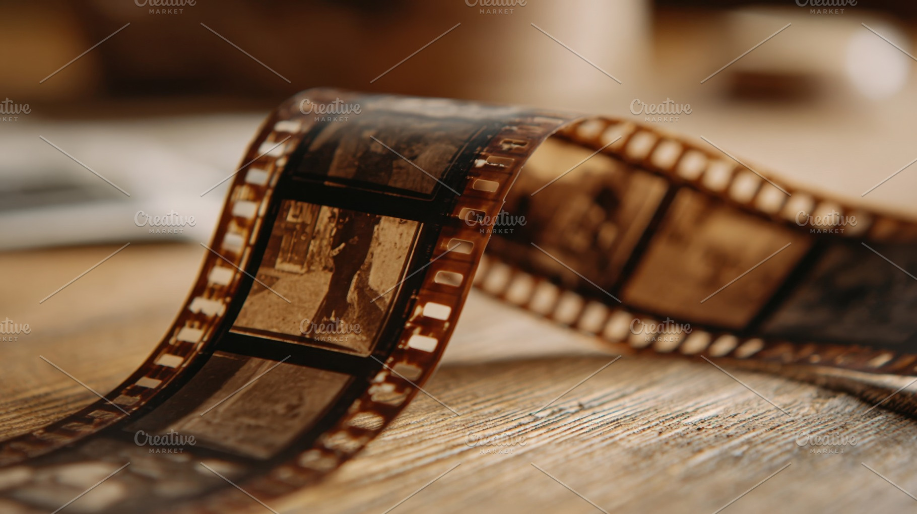 Film strip on wooden surface, a Photo by Beautiful things