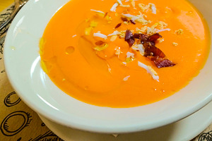 Salmorejo soup with ham and egg on rustic table, a Food & Drink Photo by DanFLCreativo