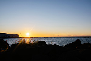 Scenic coastal sunrise view with rock foreground at Icelandic waterfront, a Nature Photo by AS photostudio