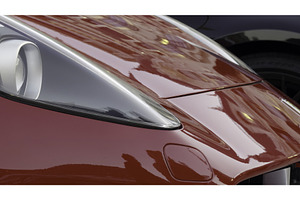 Red sports car reflecting city, a Transportation Photo by Media Whale Stock