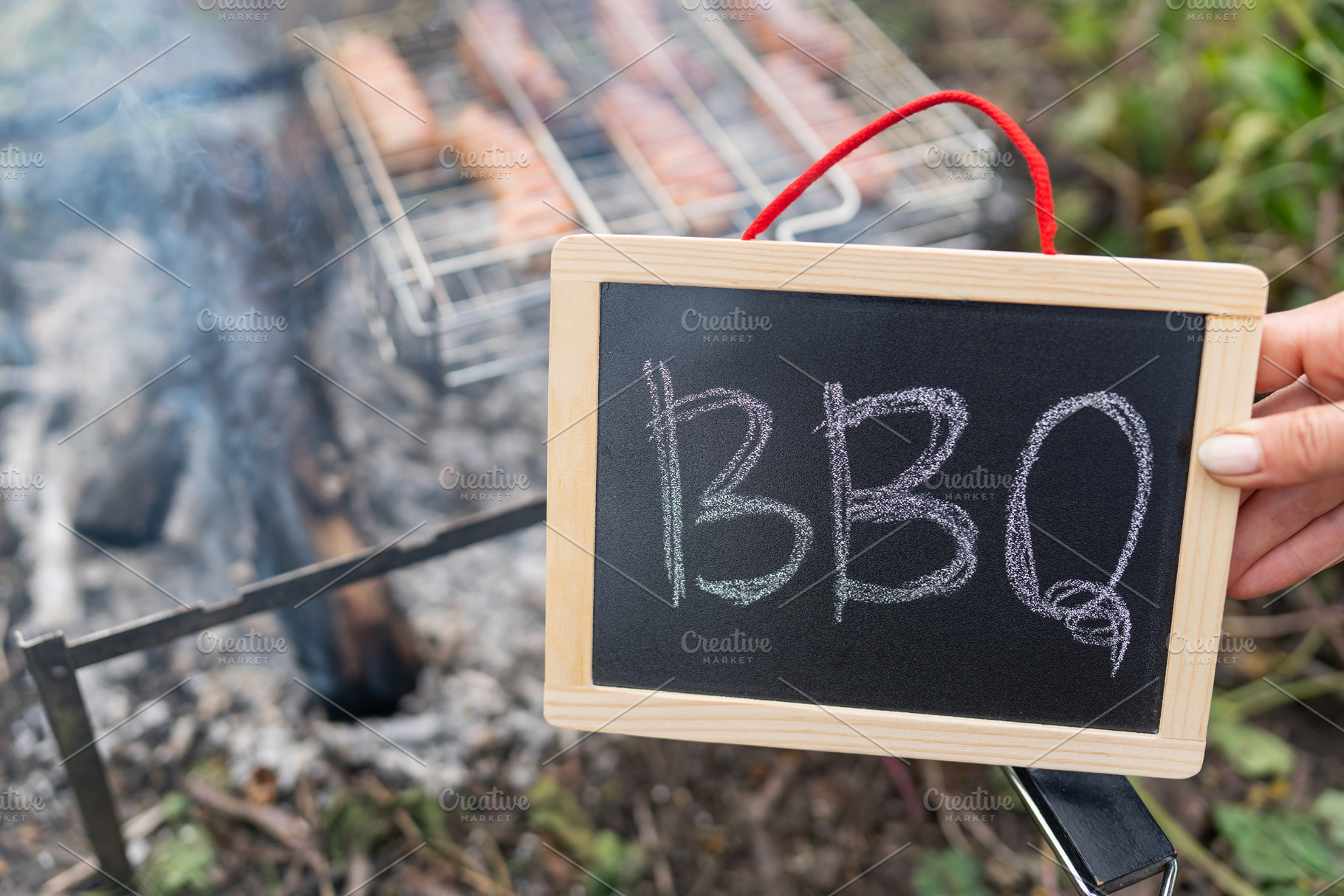 The inscription barbecue on a black plate, a fire against the background of a g, a Food & Drink Photo by Artsaba Family