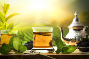 Detail of green tea with mint in glass in nature, a Food & Drink Photo by Davizro's Market