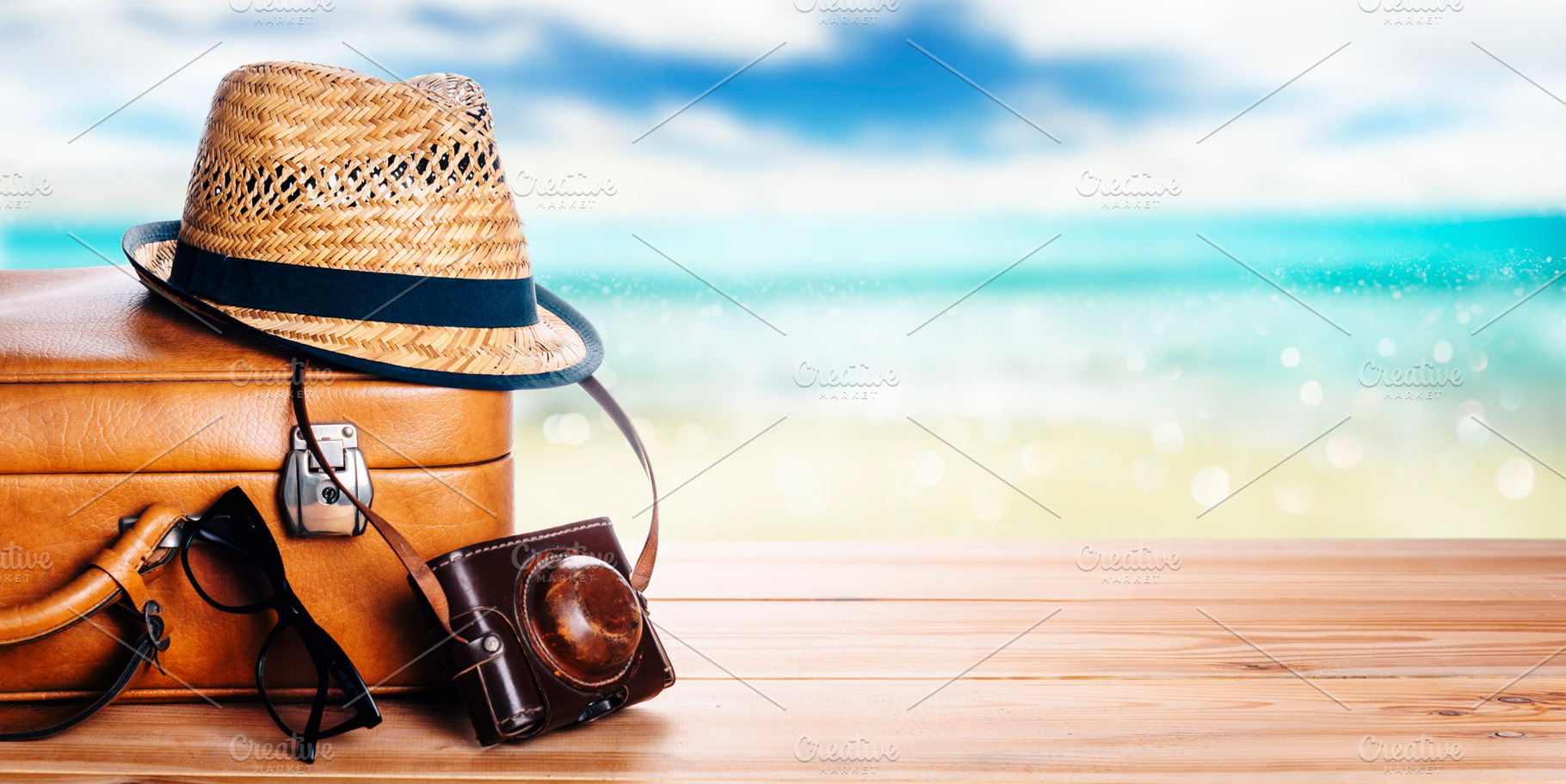 Vintage suitcase, sunglasses and hipster hat wooden deck and blu, a Holiday Photo by hitdelight