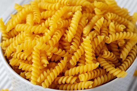 Raw Dry Organic Rotini Pasta Ready to Cook, side view. Close-up., a Food & Drink Photo by LiudmylaChuhunova