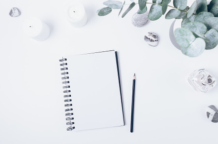 Blank notebook with pencil next to candles, a Beauty & Fashion Photo by progressman