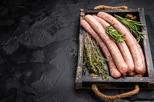 Raw sausage packed with herbs and spices, inviting you to create, a Food & Drink Photo by composter-box@mail.ru