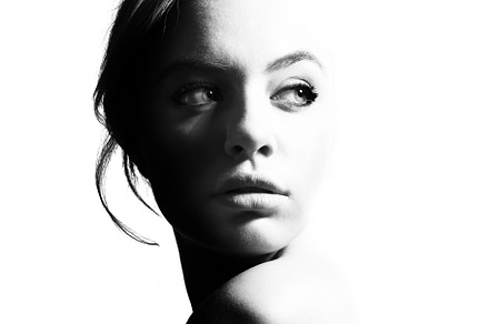 High contrast black and white portrait of a beautiful girl featuring profile