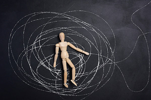 A wooden, articulated figure of a man lies in the center of a ch, an Abstract Photo by ndanko