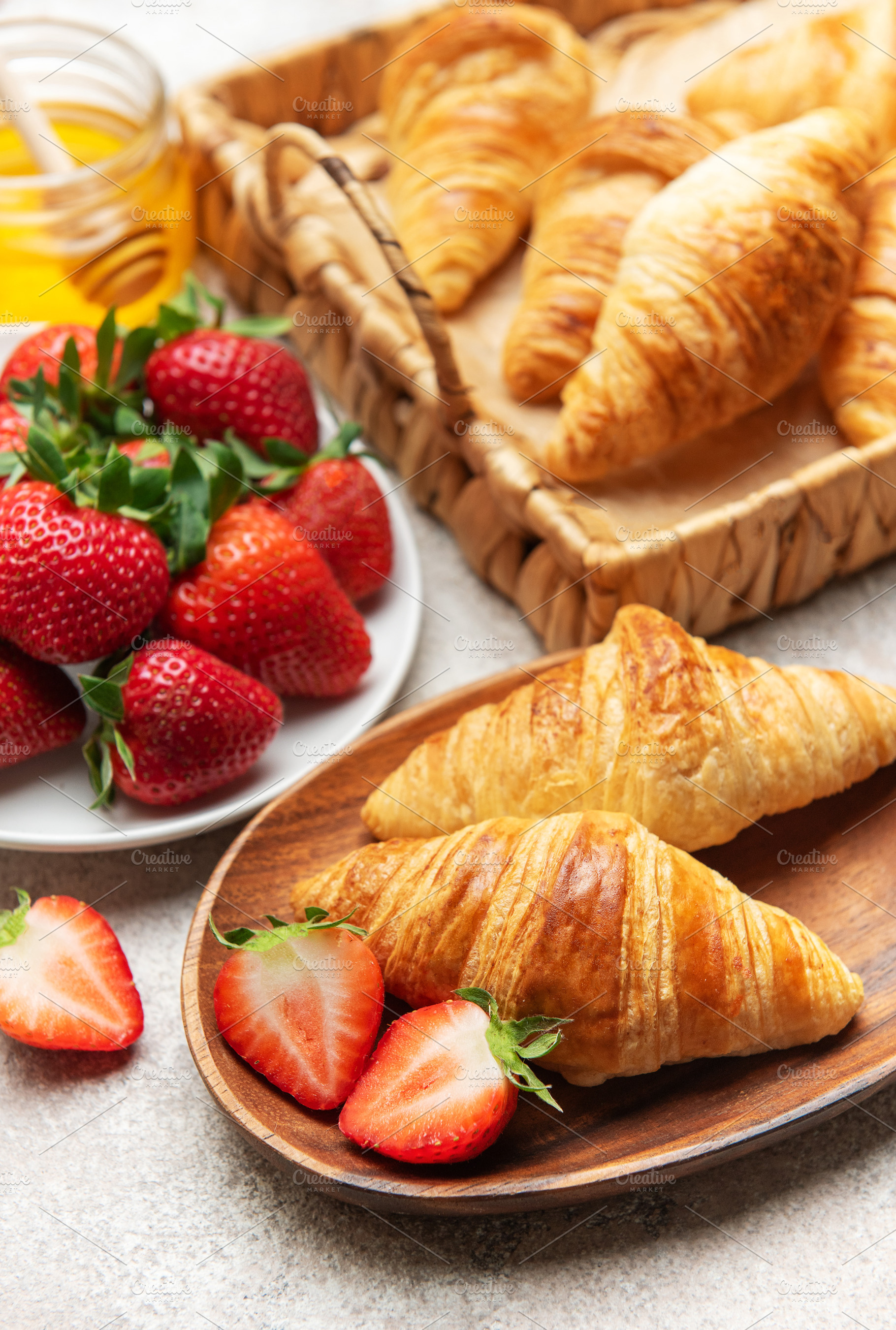 Delicious french croissants with fresh strawberries and honey fo, a Food & Drink Photo by Olena Rudo