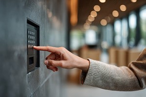 Hand entering security code on keypa, a Photo by Pixeness Studio