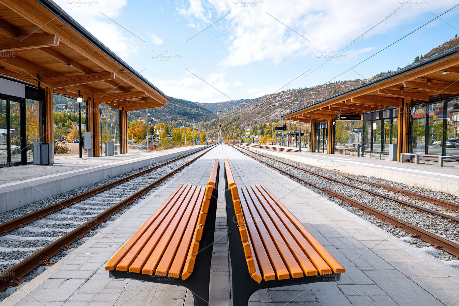 Double-track railway station in Scandinavia with scenic mountain view and woode, a Photo by AlyaAnd