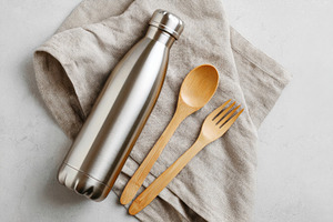 Stainless steel water bottle with bamboo utensils, a Food & Drink Photo by AlyaAnd