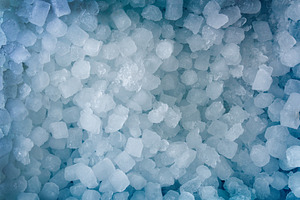 Blue background with a pile of small ice cubes top, a Food & Drink Photo by Davizro's Market