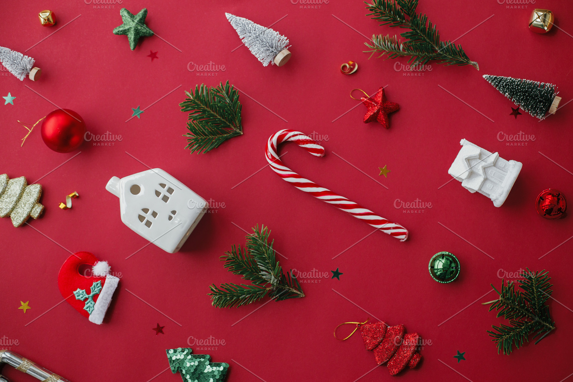 Stylish christmas festive decorations on red background flat lay, a Holiday Photo by Sonjachni