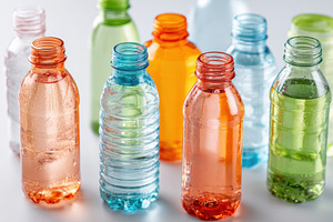 Colorful plastic water bottles on white background, a Food & Drink Photo by AlyaAnd