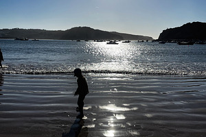 Child Playing in Reflected Sunset on a Beach in Cascais, Portugal, a Photo by AS photostudio