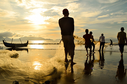 Fishermen Pulling Nets As the SunSet
