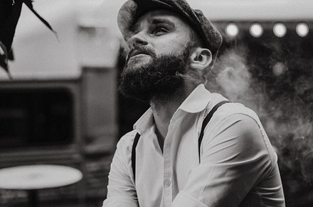 Young bearded man in a cafe, a Person Photo by EVA.studio