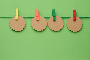 Four round, shaped craft paper tags, secured with multi-colored, a Background Photo by ndanko
