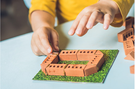 Close up of child's hands playing, an Architecture Photo by Elizaveta Galitskaya