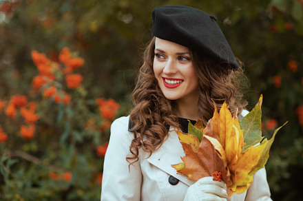 happy young female in beige trench coat, a Person Photo by Alliance Images