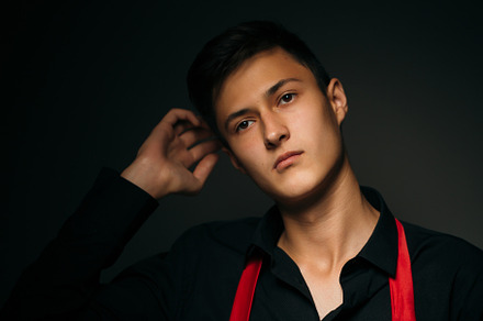 Portrait young guy on a dark studio containing face, man, and guy