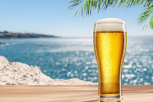 Glass of chilled beer on table, a Food & Drink Photo by Volff