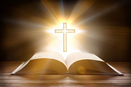 Bible with bright cross on table, an Abstract Photo by Davizro's Market
