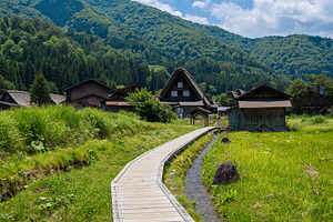 Wooden path crossing traditional village of Shirakawa-go in Japa, a Nature Photo by GoodGoods